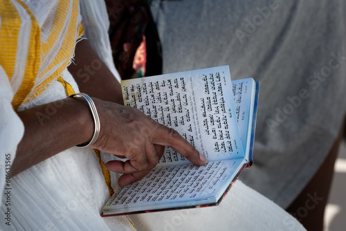 Ethiopian woman reading psalms in Hebrew during a celebration of the Sigd holiday in Jerusalem.  photo
