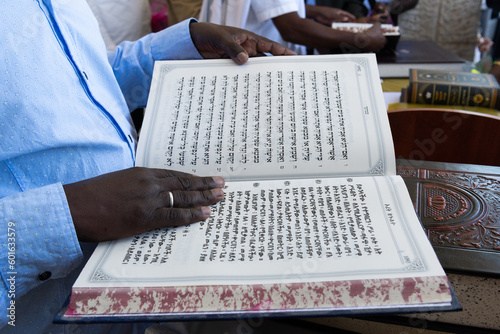 Jewish Ethiopian man reading from the Jewish bible, Old Testament or Torah in Amharic photo