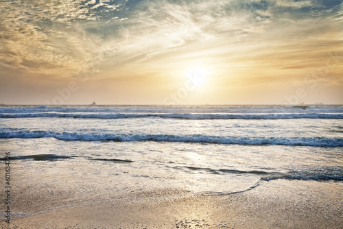 Fototapeta Naklejka Na Ścianę i Meble -  Beach, water and ocean with sunrise and mockup with blue sky and waves on horizon. Sea landscape, outdoor and nature with sunshine at the coast and seaside with sand and no people with clouds