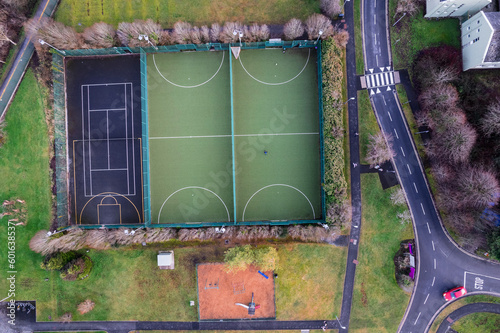Sport ground in a college or university student camp. Aerial top down view on basketball, tennis and mini soccer or football court and walking path.
