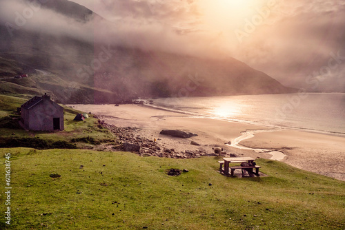 Wool sheep on green grass. Stunning nature scenery of Keem bay and beach  county Mayo  Ireland. Popular travel destination.