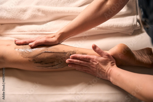 Skilled masseuse carrying out anti-cellulite massage session photo