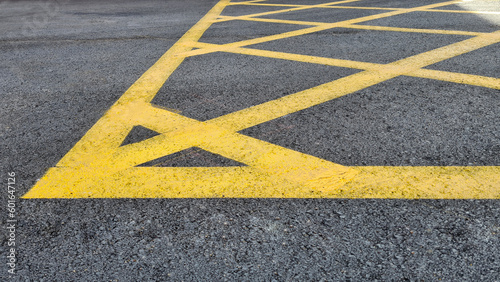Yellow line. Band of yellow reflective paint on a black asphalt. Yellow line on road texture. Road marking. High quality photo