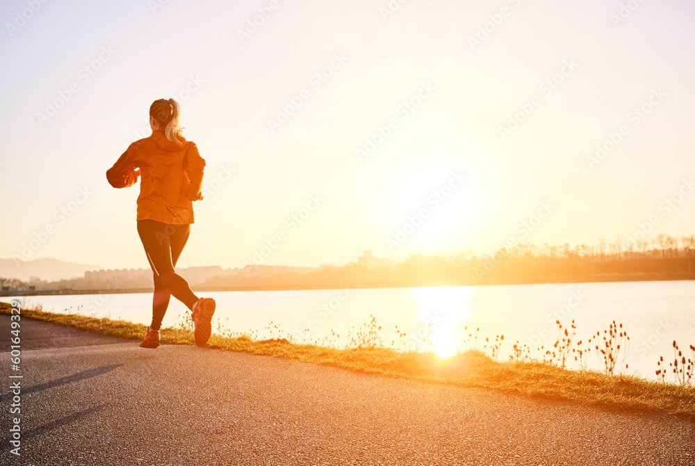 Woman running outdoors. Healthy lifestyle concept, people go in sports. Silhouette family at sunset. Health care, authenticity, sense of balance and calmness.
