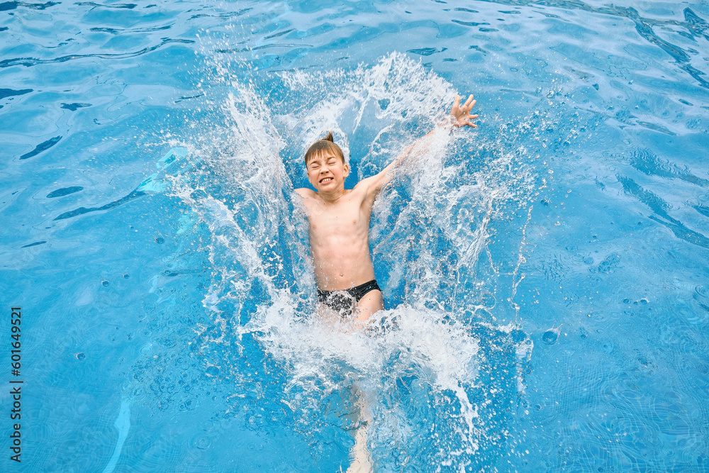 Child jump splash, swim in the pool, sunbathes, swimming in hot summer day. Relax, Travel, Holidays, Freedom concept.