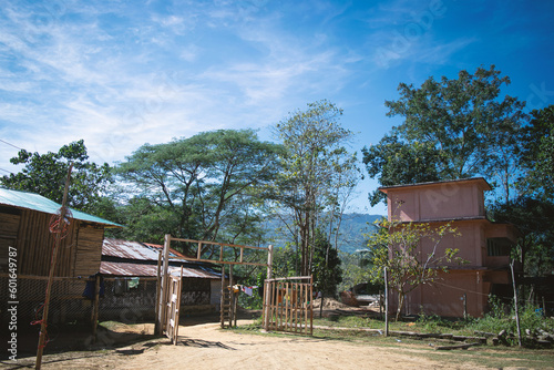 Indian village houses with a large yard, sunny day in Bangladeshi village © Shuvro