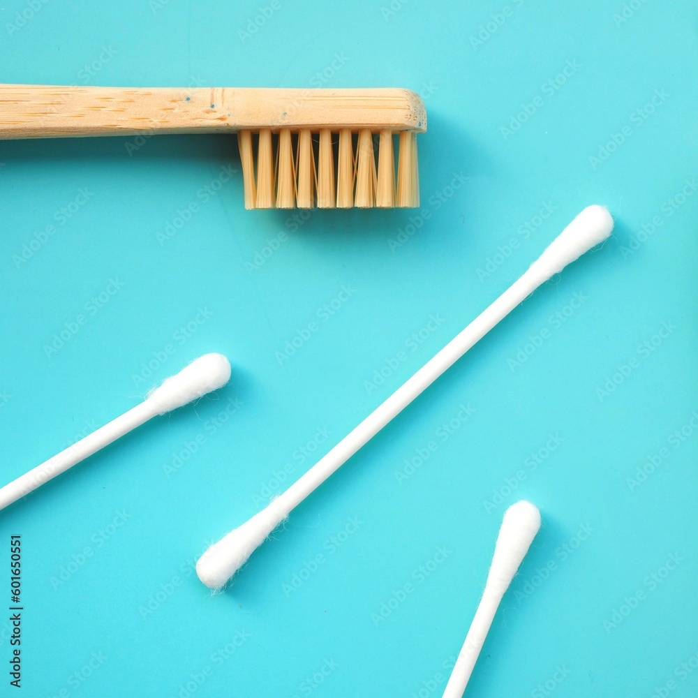 A background with a bamboo toothbrush and biodegradable cotton buds A background with a bamboo toothbrush and biodegradable cotton buds