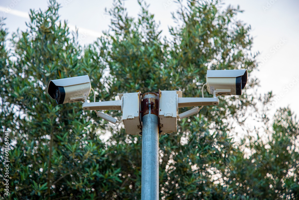 CC.TV. cameras on metal poles in public parks to monitor, observe and record evidence of incidents for investigation. CC.TV. cameras on metal poles in public parks to monitor, observe and record evidence of incidents for investigation.