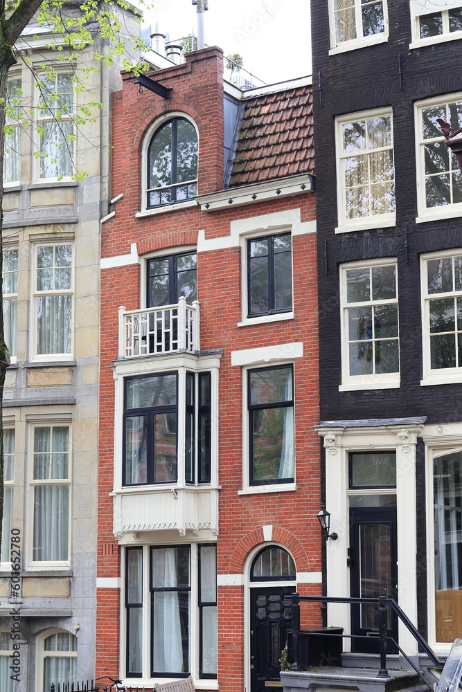 Fototapeta premium Amsterdam Canal Red Brick House Facade, Netherlands