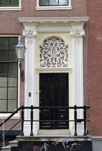 Amsterdam Nieuwezijds Voorburgwal Street White Decorated House Entrance with Lantern, Netherlands