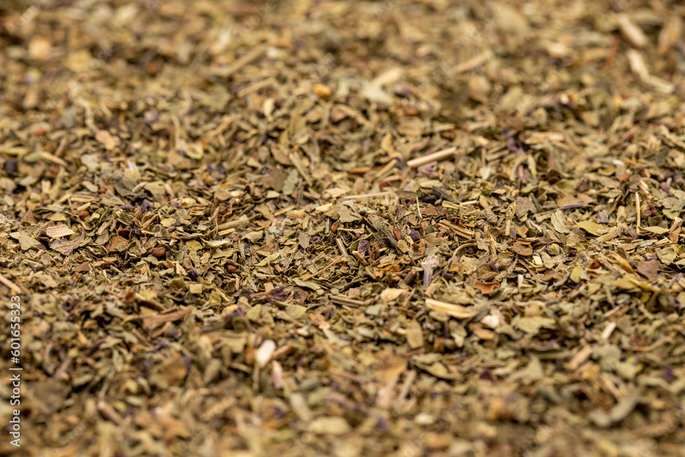 Close-up Dried crushed basil background. Dried ground basil powder spices. Spice background. Close up
