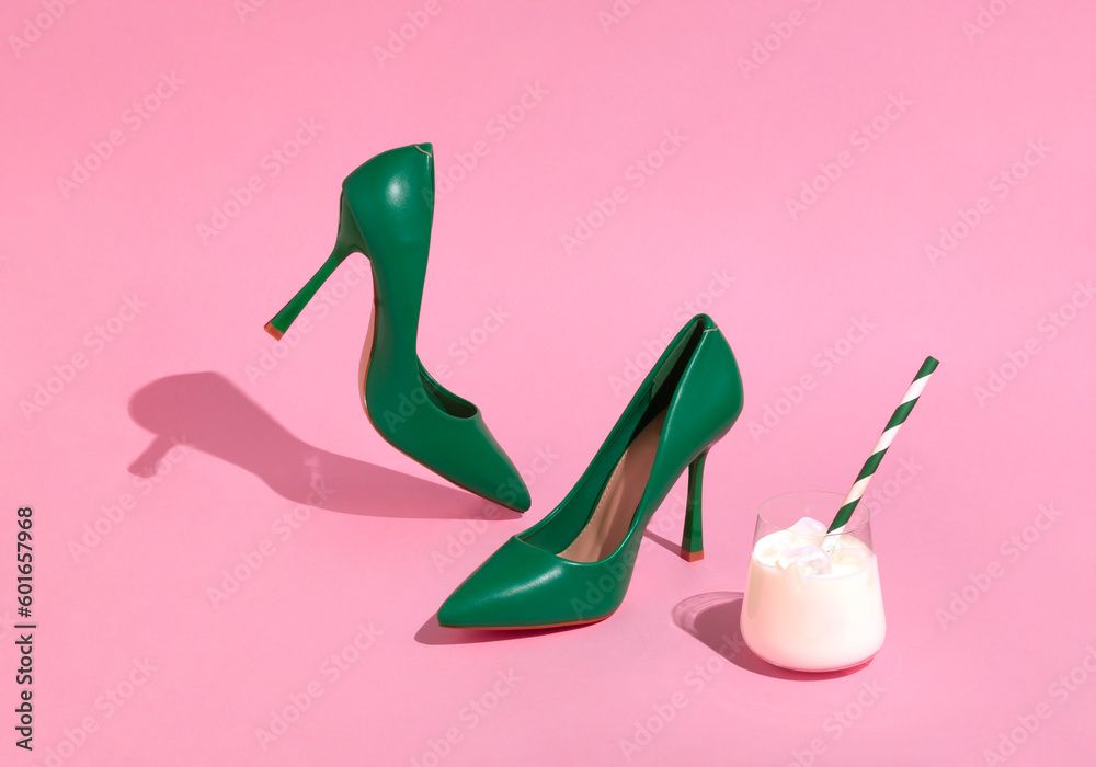 Creative scene of women's green shoes and white cocktail. High heel shoes on sunny day and pink background. Creative scene of women's green shoes and white cocktail. High heel shoes on sunny day and pink background.