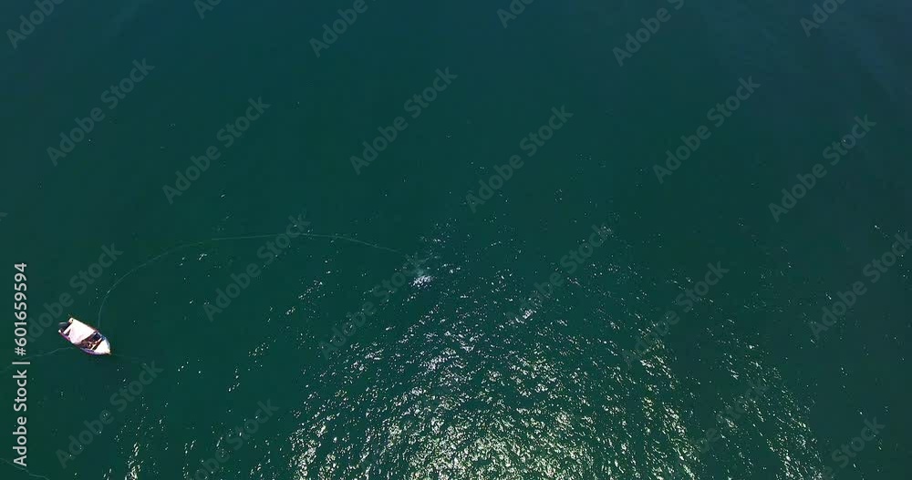 Forward Aerial Over Bay with Fishing Boat and Roll Reveal to Large Beach with Distant Mountains Forward Aerial Over Bay with Fishing Boat and Roll Reveal to Large Beach with Distant Mountains
