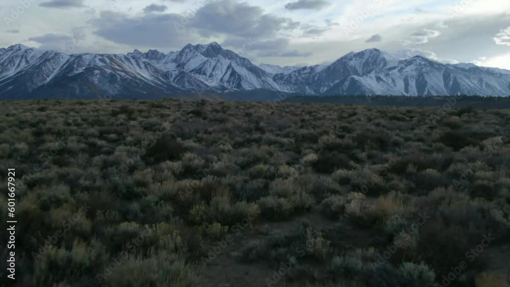 Aerial Cinematic drone Mammoth Lakes California Sierra Nevada hilltop hot spring field and mountain landscape late after sunset up to the forward pan up reveal movement Aerial Cinematic drone Mammoth Lakes California Sierra Nevada hilltop hot spring field and mountain landscape late after sunset up to the forward pan up reveal movement