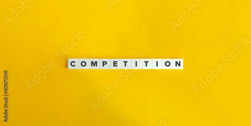 Competition Word on Block Letter Tiles on Yellow Background. Minimal Aesthetics.