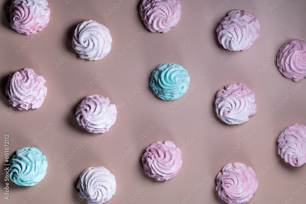 Multicolored, pink, blue marshmallows and meringues close-up, flat lay, pattern