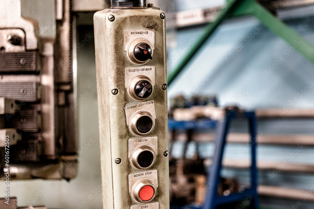A worker is operating remote swtich to control overhead crane at the factory warehouse. Industrial working action photo. Close-up. A worker is operating remote swtich to control overhead crane at the factory warehouse. Industrial working action photo. Close-up.