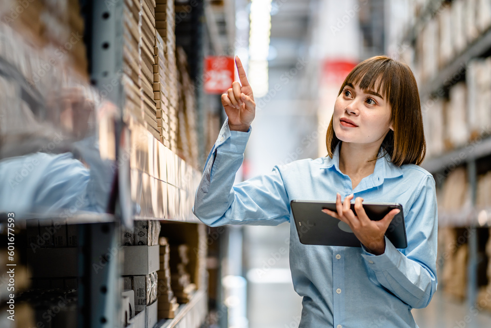 Women warehouse worker using digital tablets to check the stock