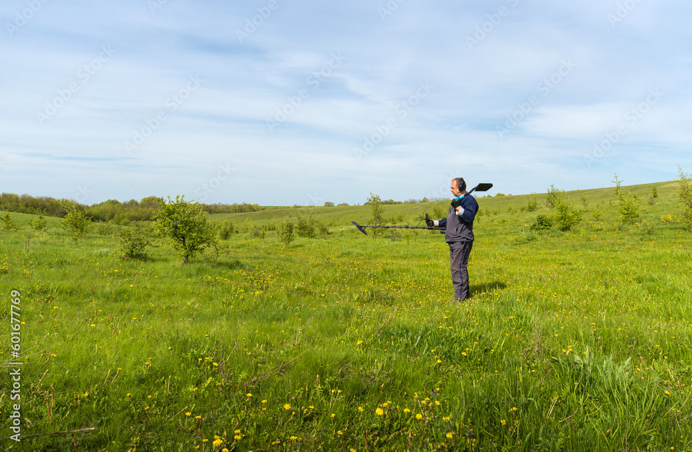 Metal search. A man holds a metal detector in his hand. Search for treasures. Search for antique coins