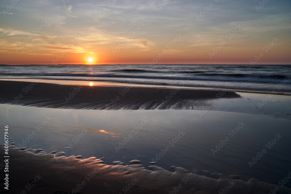 Fototapeta premium Sandy beach in the rays of the setting sun on the island of Wolin