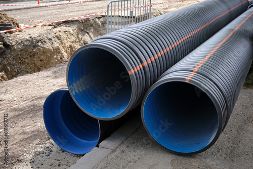 Wallpaper Mural Large plastic corrugated pipes for water supply lie on the street in the city. Torontodigital.ca