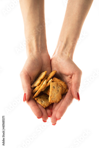 Italian crispbreads isolated on a white background. crackers in female hands. Woman holding crackers isolated on white. High quality photo