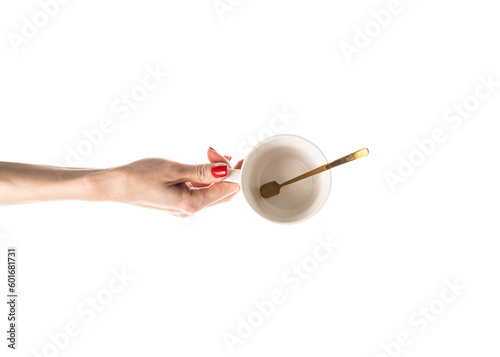 Female hands hold a white ceramic cup on white background. Female hands with fresh red manicure. Isolated on white background.