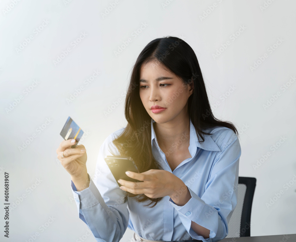Asian woman depressed while checking bank account balance and credit card bills payment, Income is not enough for expenses.