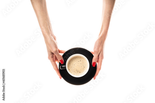 Female hands hold a white ceramic cup with a saucer on white background. Coffee cup, cup with coffee, latte, cappuccino, three-in-one coffee. 