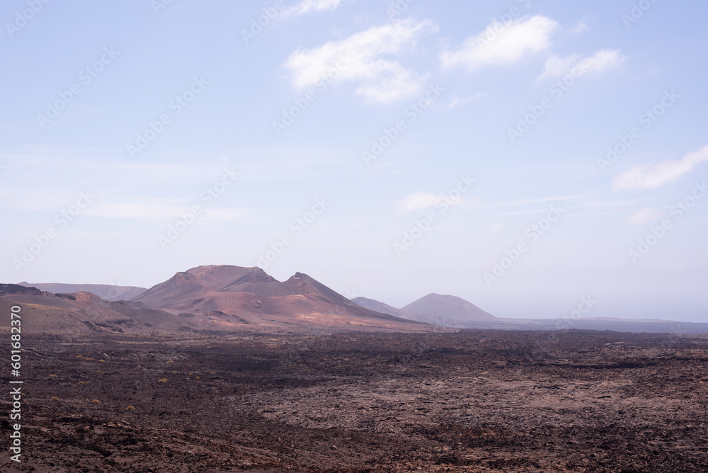 Amazing lunar landscape of Timanfaya National Park on the volcanic island of Lanzarote in Spain. Amazing lunar landscape of Timanfaya National Park on the volcanic island of Lanzarote in Spain.