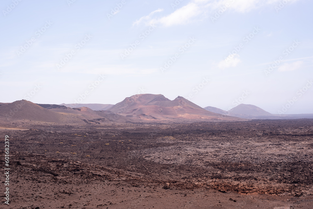Amazing lunar landscape of Timanfaya National Park on the volcanic island of Lanzarote in Spain. Amazing lunar landscape of Timanfaya National Park on the volcanic island of Lanzarote in Spain.