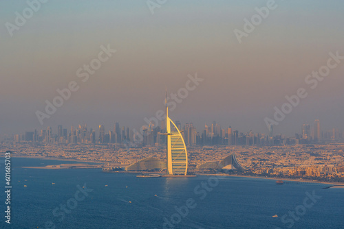 Obraz na plátně Dubai seaside skyline and Burj Al Arab luxury hotel aerial view and skyscrapers far away at sunset, United Arab Emirates