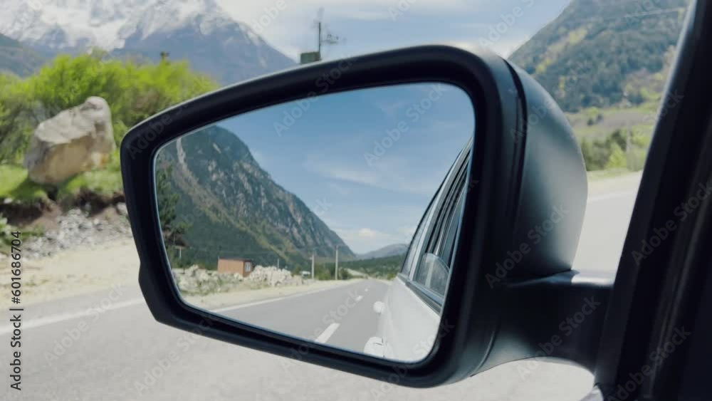 Reflection in car mirror in mountain road, summer green Reflection in car mirror in mountain road, summer green