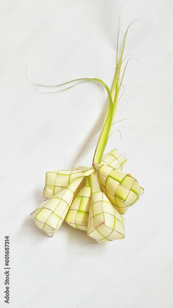 Ketupat or rice dumpling is tradition food during celebration eid fitri, eid mubarak, and eid adha. Ketupat is natural rice made from coconut leaves for cooking isolated on white background