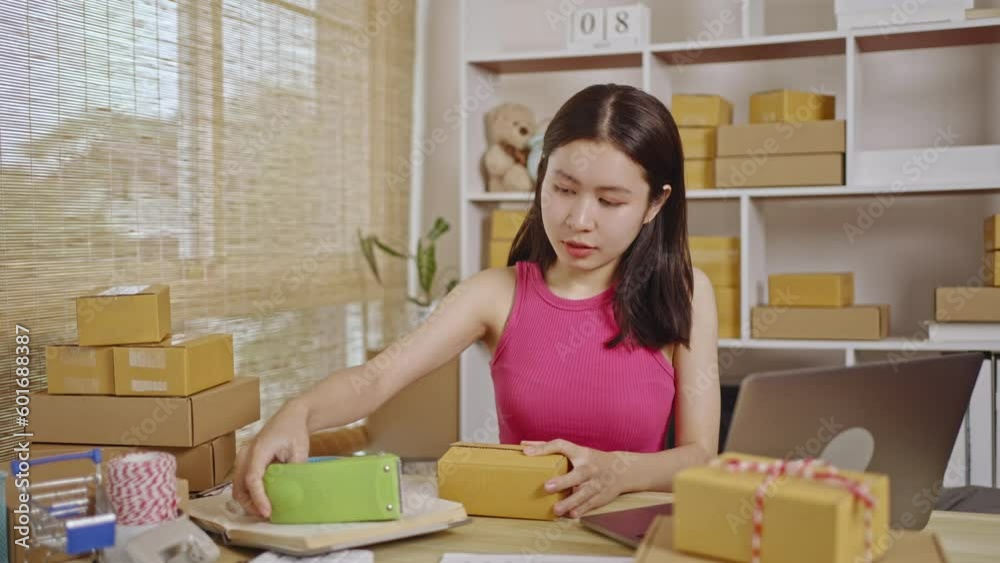 Pack products, Woman packing goods into a postal box, Online Shopping, Freelance working, Sell products online. Pack products, Woman packing goods into a postal box, Online Shopping, Freelance working, Sell products online.