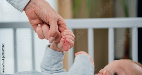 Quadro em tela Close-up of hand of mother and infant at children room background