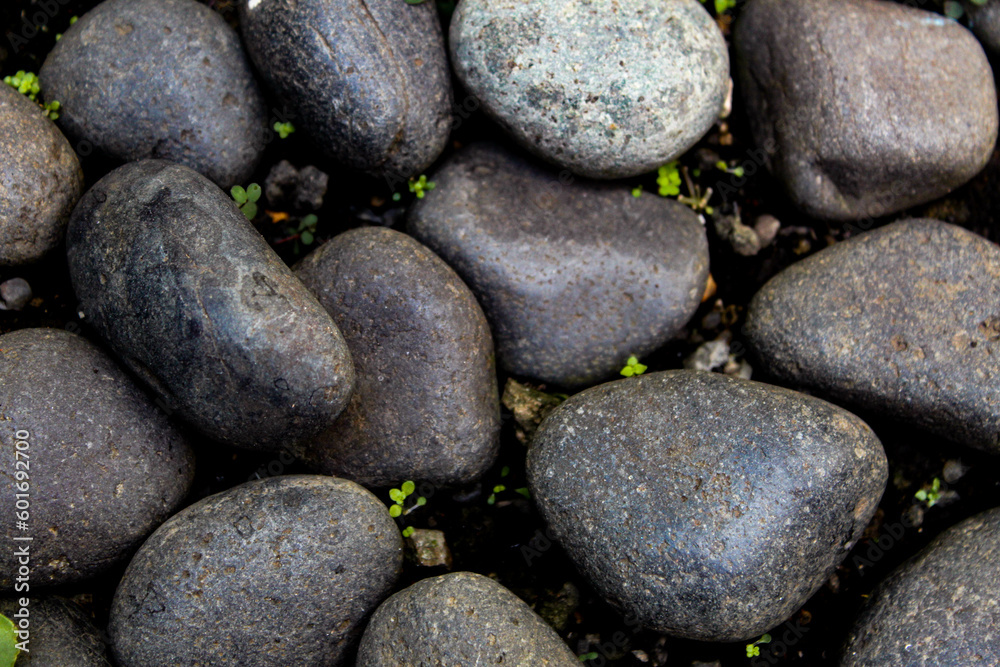 dark aged rocks with depth, round rocks. coarse, gray stone or rocks texture for background. natural theme dark aged rocks with depth, round rocks. coarse, gray stone or rocks texture for background. natural theme