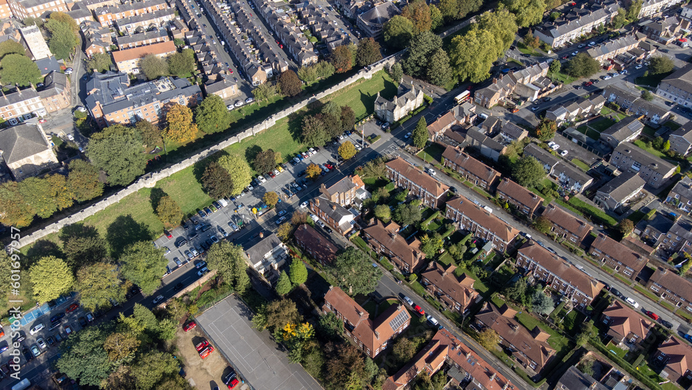 Aerial photo of the town of York located in North East England and founded by the ancient Romans, showing the York Minster Historical Brick Wall and housing estates that are around the wall.