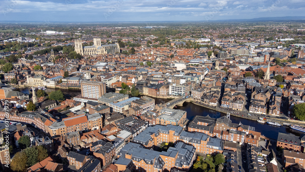 Obraz premium Aerial photo of the town of York located in North East England and founded by the ancient Romans, showing the York Minster Historical Cathedral in the main town centre along the river side.
