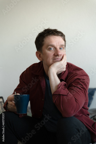 caucasian guy relaxing and daydreaming in bed at home