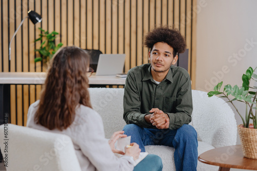 young man in consultation with psychologist is taking care of mental health. Psychotherapy for treatment of disorders and depression, insomnia. African American guy tells doctor about his problems