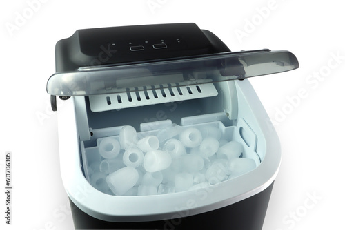 a lot of clean ice are made by black modern design ice maker during summer on the white table with background of white cement wall photo