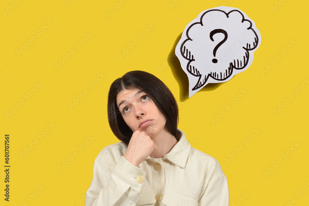 thoughtful young woman on yellow background, question mark thoughtful young woman on yellow background, question mark