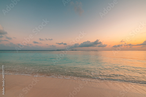 Summer beach vacation. Closeup Mediterranean sea sandy beach. Idyllic peaceful shore calm waves colorful amazing sky clouds. Dream travel landscape. Relaxing sunset sunrise horizon seascape reflection