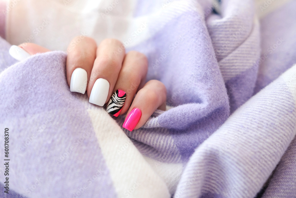 Beautiful female hands with manicure on a purple background. Tinted nail design. Summer pink manicure. Copy space. Beautiful female hands with manicure on a purple background. Tinted nail design. Summer pink manicure. Copy space.