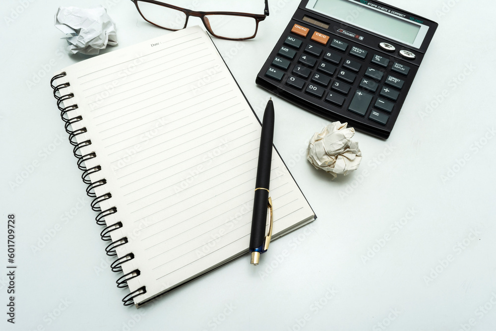 Top view white clean office table, White blank spiral notebook and pen for notes with copy space Top view white clean office table, White blank spiral notebook and pen for notes with copy space