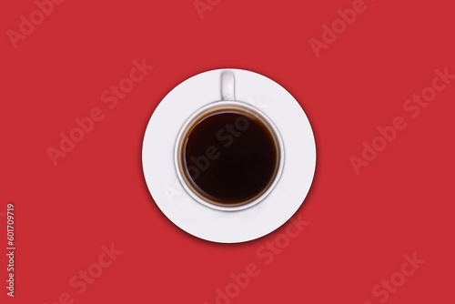 Top view of a coffee mug on red background. cup of black coffee on a vivid red desktop background.