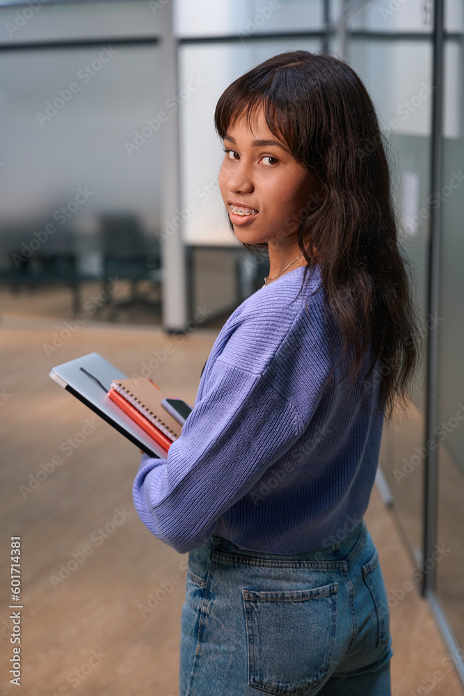 Beautiful woman looking at camera in hallway Beautiful woman looking at camera in hallway