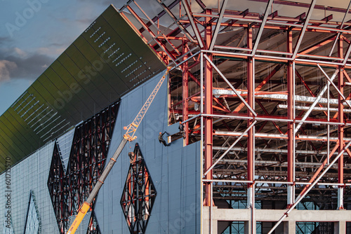 Installation of facade panels to the wall of a modern building.