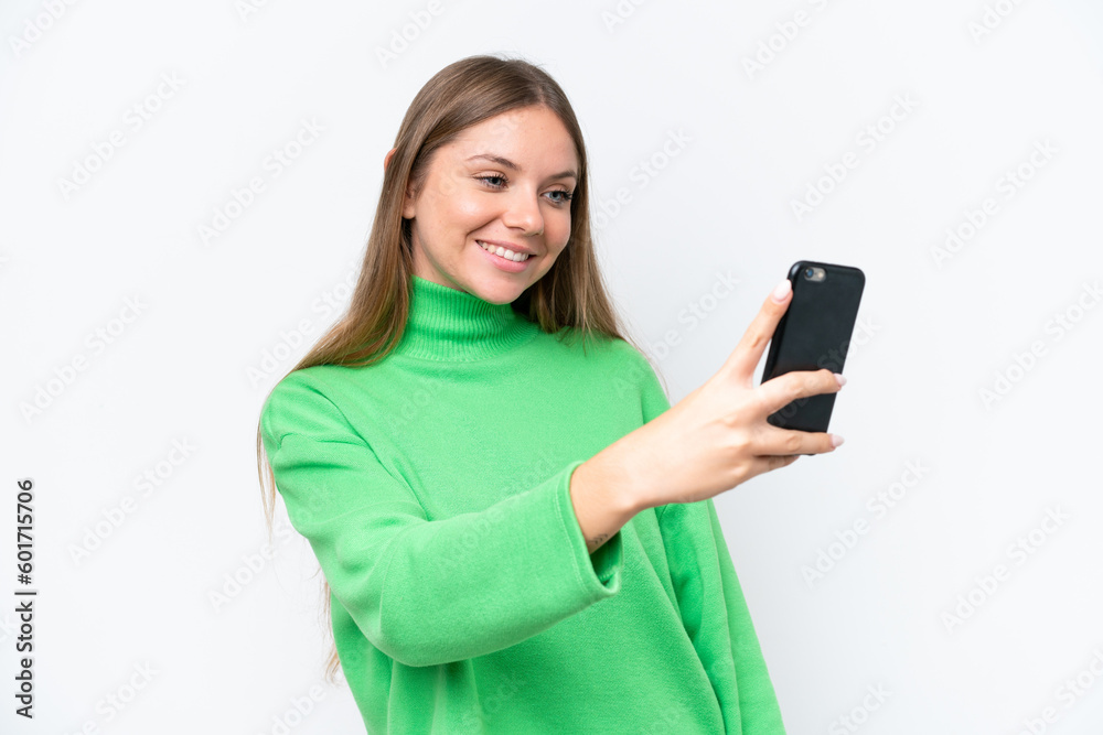 Young beautiful blonde woman isolated on white background making a selfie Young beautiful blonde woman isolated on white background making a selfie